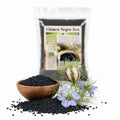 Semințe de chimen negru BIO Nigella sativa în bol de lemn cu floare albastră de nigella, 200g Biovicta