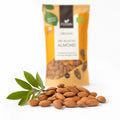 Migdale coapte BIO, 140g — migdale coapte întregi și ramură verde de migdal, prezentare lifestyle, Biovicta
